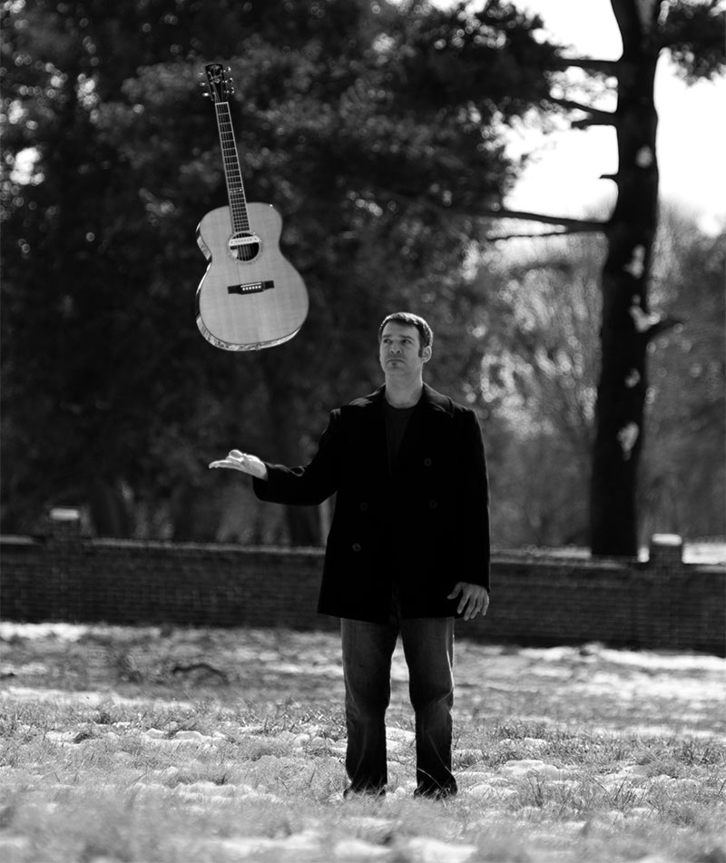 Sam Pacetti performing live with his acoustic guitar